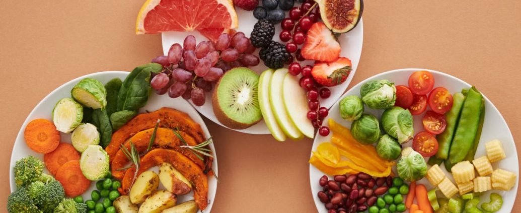 Top view of vibrant plates of fresh fruits and vegetables, perfect for a healthy lifestyle.